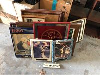 Overview photo showing a collection of framed pub and sports pictures with O.J. Simpson and Shaquille O'Neal signed pictures at front.