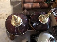 Two large red plastic Budweiser hanging pool lights with brass fixtures stacked beside each other, showing top view.