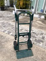 Front view of Harper hand truck showing metal frame, foldable foot plate, and two large rear wheels.