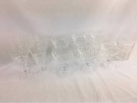 Wide view of the crystal glassware set including wine glasses, stemmed serving cups and high ball glass.