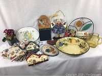 Full lot view showing all 21 items including plates, bowls, glass jug, shakers, decorative plaques and note board.