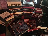 Photo showing a stack of faith books including Bibles, biographies, and religious themed books along with a Billy Graham biography and DVDs.