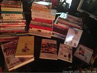 Wide view of stacked health and diet books with some smaller books and DVDs in front