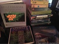 Books stacked showing titles 'Australasia Beyond 2000', 'Majesty', 'The Great Trail Canada Travel Guide','Calgary' and others to highlight content variety and condition