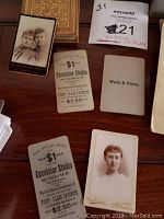 Close up of vintage cabinet card portraits including Excelsior Studio imprint and embossed borders