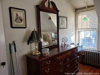 Full view of the Queen Ann style wooden bureau with matching mirror on top, showing the wood finish and overall shape.