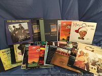 Photo showing the front view of various vinyl record albums including The Blues Brothers, Kenny Rogers, and a Christmas album.