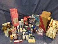 Photo showing an array of Avon cosmetic bottles, tubes, and other beauty products, two Avon encyclopedias, and packaged items; items arranged on a surface.