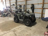 Side view of ATV with helmets on rear rack