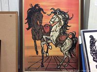 Frontal view of framed abstract horse oil painting with two horses on a gradient orange-pink background.