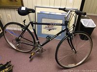 Full side view of black Tangier Jamis 7 speed bike showing frame, seat, and tires.