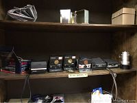 Wooden shelf displaying cameras and accessories