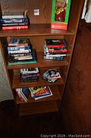 Bookshelf loaded with multiple sports-themed hardcover books, mostly focused on Yankees and baseball.