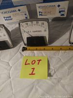 Five Yokogawa panel meters displayed with a ruler showing scale and original boxes in the background.