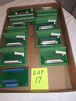 Multiple Phoenix Contact green interface modules mounted on circuit boards with connectors, placed in cardboard box