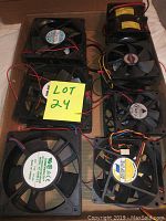 Photo showing a group of 18 assorted mini electronic axial cooling fans laid out together, with some wiring visible and labels on fan motors.
