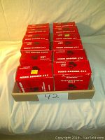 12 Ademco 747 indoor sirens in red boxes arranged in a tray.