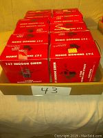 Nine boxed Ademco 747 indoor sirens in original red packaging.
