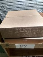 Closed cardboard boxes containing the circuit boards, stacked one on top of the other