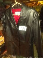 Front view of black leather coat showing button closure and collar.
