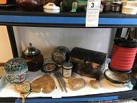 Overview photo of potpourri bowls, granite hearts, votive candle, and collapsible lantern on shelf