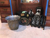 Photo of metal pot with embossed brass cranes and grouped Asian decorative items: lacquer box, inlaid vase, miniature folding screen, painted tray