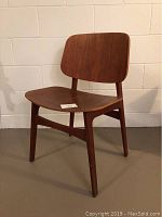 Front three-quarter view of wooden chair showing full profile