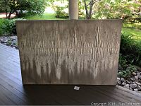 Front view of large decorative wall art on canvas with textured horizontal pattern and raised vertical wooden slats.