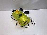 Yellow translucent Fog F/X fog machine with ventilation slots, power cord, and wired remote control.
