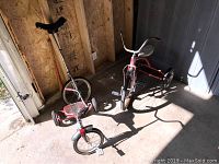 Overall view of the unicycle and two tricycles placed on the floor with sunlight casting shadows, showing general condition and design.