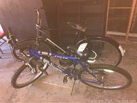 Both bicycles leaning against wall in garage space