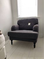 Front view of grey Stocksund armchair under window