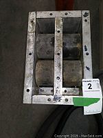 Top view of one roller unit showing three cylindrical rollers within metal frame