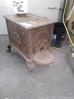 Front left view showing decorative beaver panel and overall rust condition