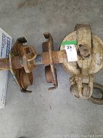 Close-up of snatch block and part of trolley showing surface rust and wear.