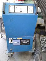 Front view of blue metal dust collector unit on caster wheels showing control panel