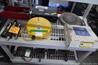 Various saw blades, diamond blade in box, air hose reel, dead centre morse adapters lying on metal shelving