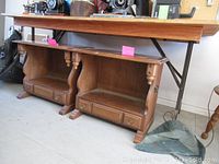 Two solid wood end tables placed side by side showing overall front and side views, surfaces, drawer fronts, and bases.