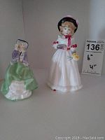 Photo showing both Royal Doulton figurines, 'Sharon' (6 inches) and 'Top O The Hill' (4 inches), side by side to illustrate their size difference.