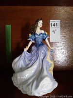 View of the Royal Doulton Rebecca porcelain figurine from the front showing the detailed colored dress and figure.