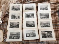 Twenty black and white Bartlett landscape prints arranged on bedding showing various countryside, mountain and architectural scenes.