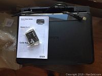 Epson Stylus NX330 printer with power cable, quick guide, and black ink cartridge showing top and connections for sale lot.