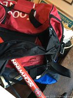 Photo showing a red and black gym bag and a red Schwinn bike tire pump beside it.