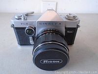 Front view of the Ricoh SingleX TLS 35mm film camera showing branded lens and camera body.