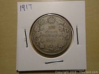 Reverse side of the 1917 Canadian silver fifty cents coin showing denomination, crown and maple leaves wreath design.