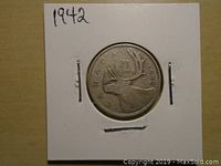 Reverse side of 1942 Canadian 25 cent silver coin showing a caribou and denomination.