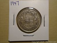 Reverse side displaying Canadian coat of arms and denomination.