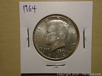 Obverse side of the 1964 Kennedy half dollar showing profile of JFK and inscriptions.