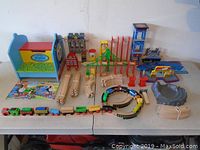 Full layout of Thomas and Friends wooden train and track set including bench, books, tracks, bridge pieces, and mountain tunnel.