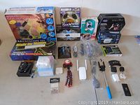 Wide shot showing entire lot of electronics and optical devices arranged on a table.